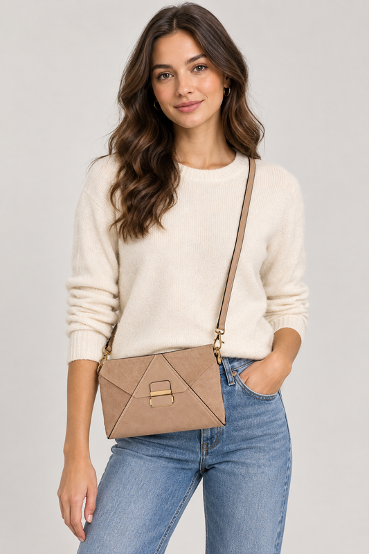 Women wearing white sweater and blue Jeans holding ALDO Cigori clutch purse, a multi-functional accessory designed to be worn as a clutch, crossbody bag, or wristlet