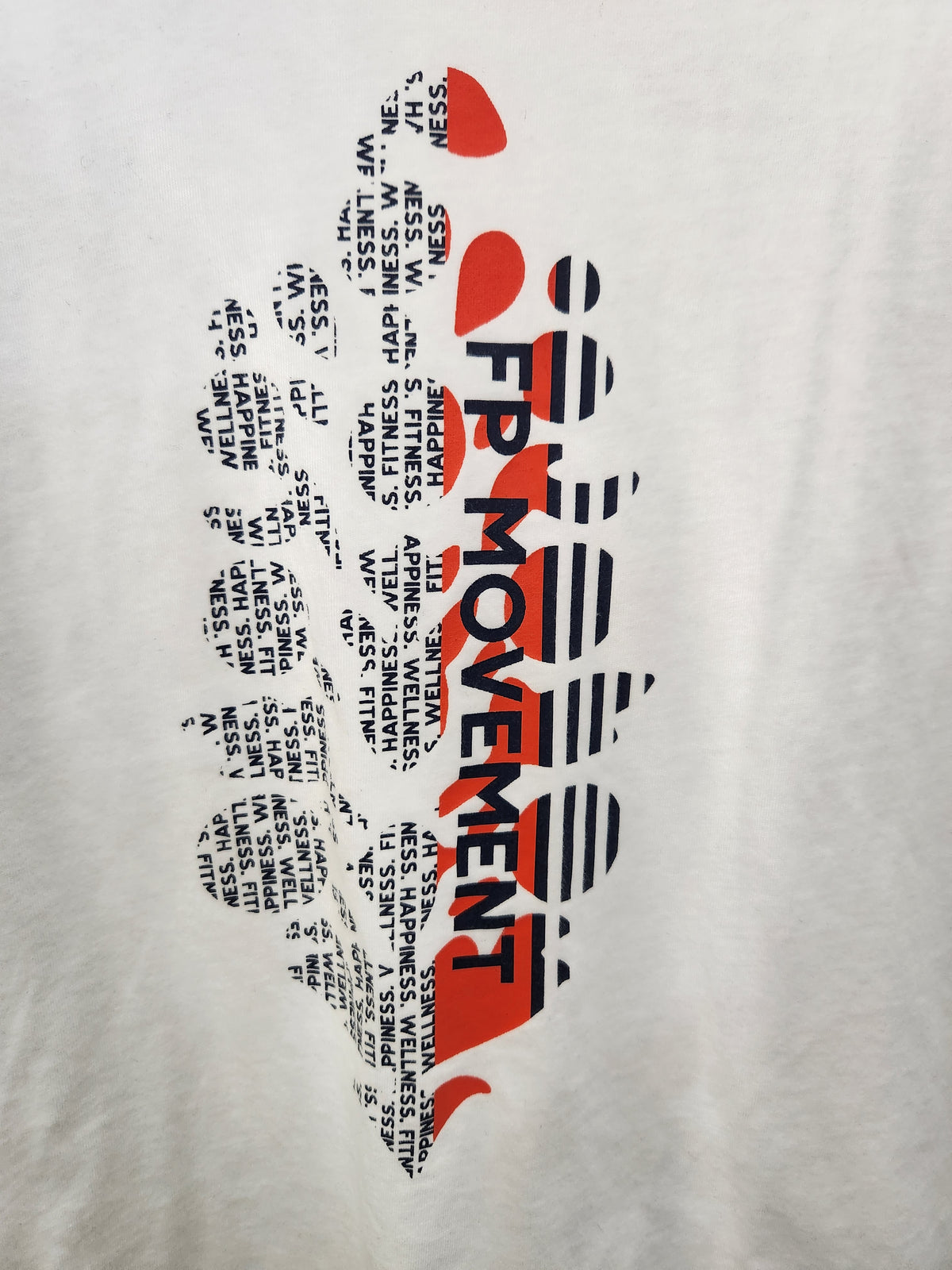 A close-up of a white T-shirt fabric featuring a graphic print of the map of New England with the words 'FPI MOVEMENT' in bold black and red lettering.