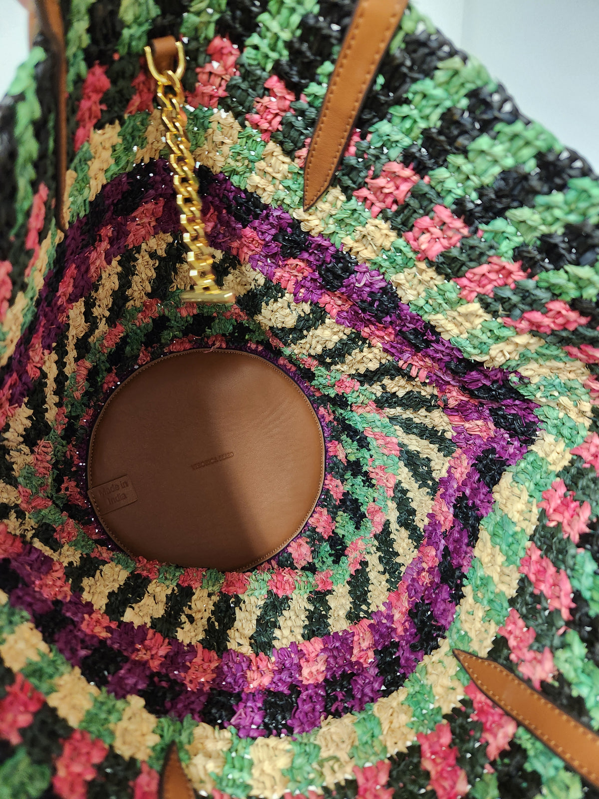 Veronica Beard Striped Raffia tote bag or anchor basket tote. A hand-woven multi-colored raffia body with dual brown leather top shoulder handles and a small golden medallion toggle closure at the top. Dust Bag included