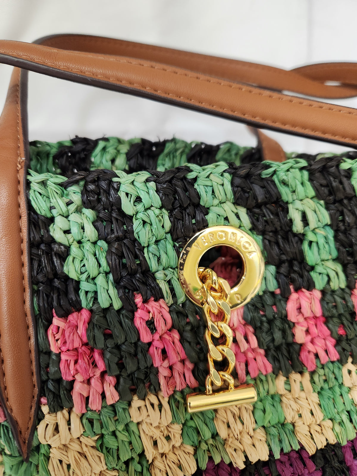 Veronica Beard Striped Raffia tote bag or anchor basket tote. A hand-woven multi-colored raffia body with dual brown leather top shoulder handles and a small golden medallion toggle closure at the top. Dust Bag included