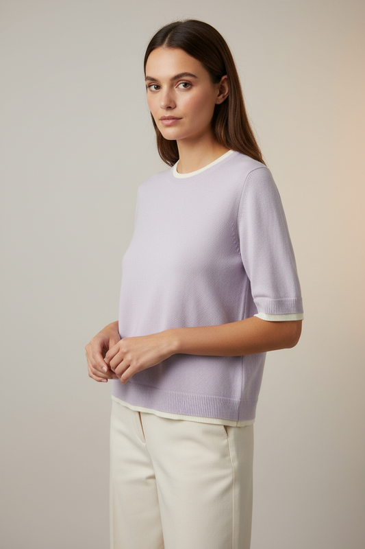 Model wearing a pale lavender French Connection knit short-sleeve sweater with cream trim